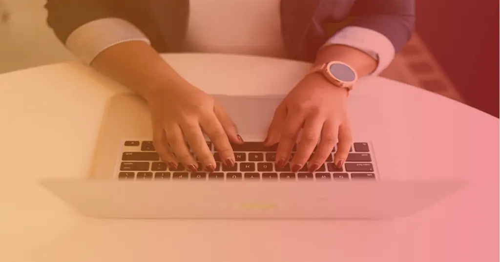 A woman's hands type on a macbook. With our help, learn how to retain and engage your customers with these proven strategies.