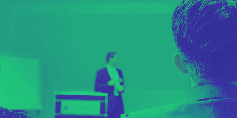 The presenter in the background is being too nice and giving away all his secrets for free, which is why his content marketing is failing — the person in the foreground is taking all his content and never being of value back.