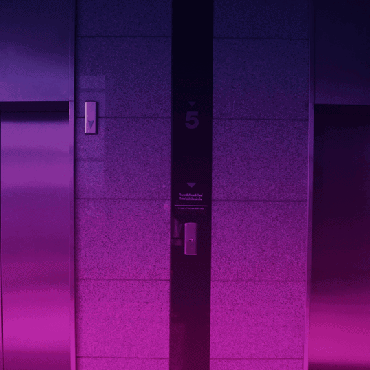 Two elevators with a purple gradient overlaid. Writing an elevator pitch is tough, but if you follow these guidelines, you'll end up with an elevator pitch that rocks.
