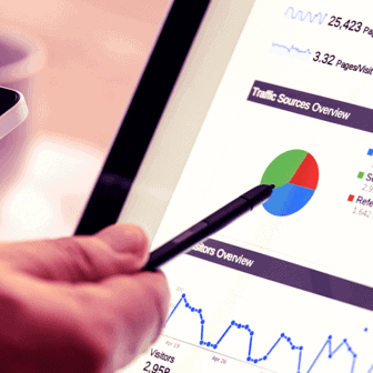 A hand with a pen pointing to a graph on a computer. SEO best practices aren't often as cut and dry as a graph and a list of data. Learn more.