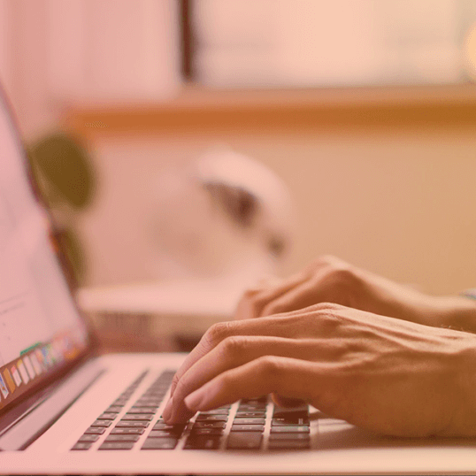 A person creates content on laptop resting on a desk. Content is one of the best tools to drive traffic to your website. It can get you closer to a sale than traditional methods, and it can improve your site traffic and sales.